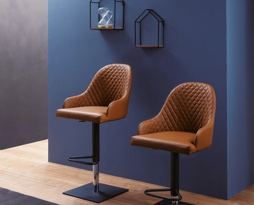 Sgabello con basamento in metallo e seduta rivestita in pelle con interno trapuntato Prometeo di Ozzio